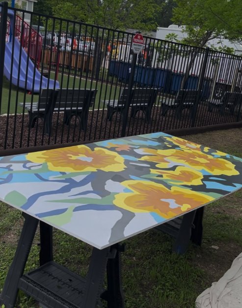 A freshly painted picnic table at Pecan Springs Commons